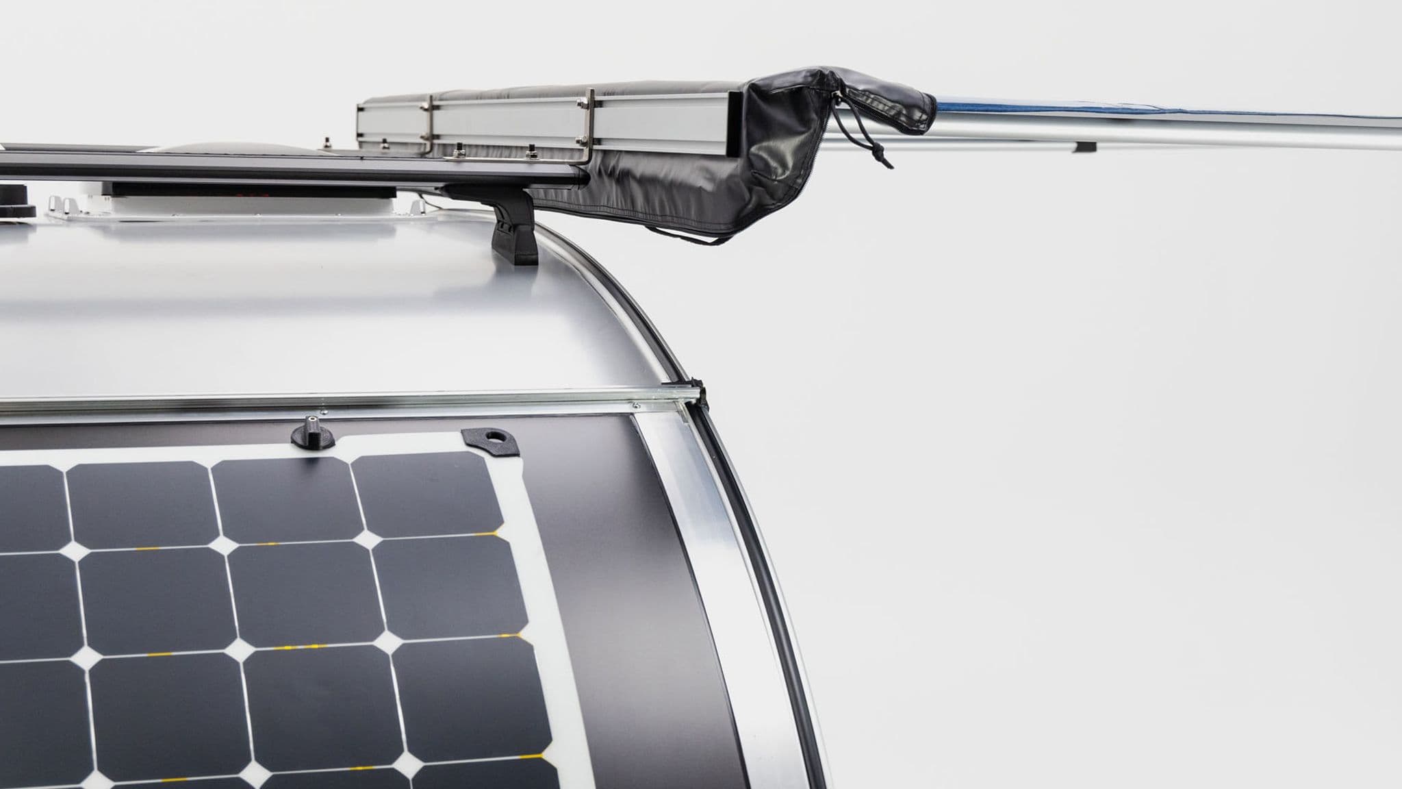 Close-up of the Escapod TOPO trailer’s roof-mounted solar panel and awning, showcasing its off-grid power capabilities.